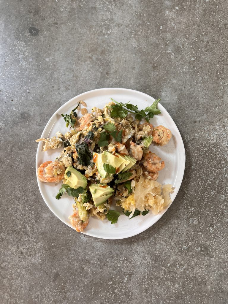 Shrimp stir-fry with cauliflower rice and avocado.