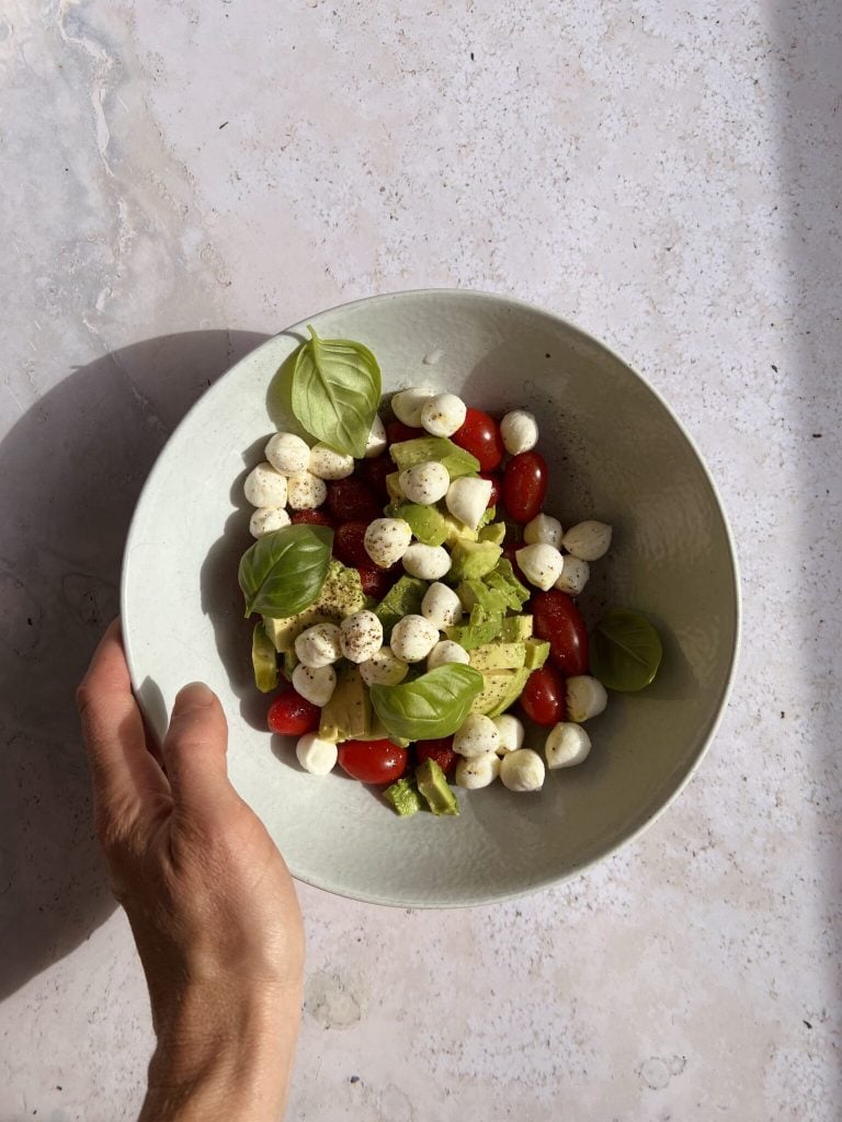 Bowl of tomato, basil, and mozzarella caprese.