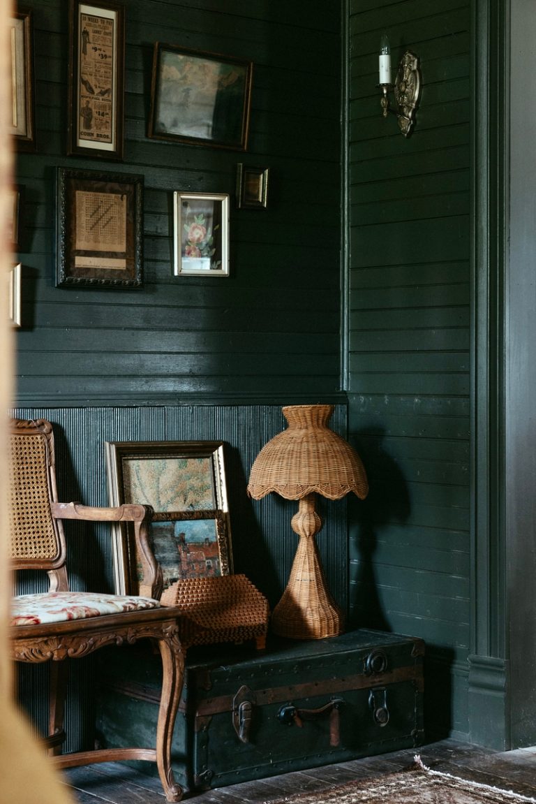 vintage farmhouse with deep green walls and rattan
