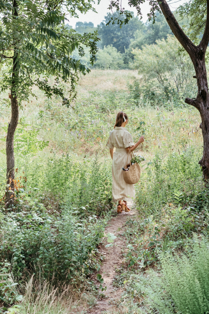 Woman walking in a field of wildflowers