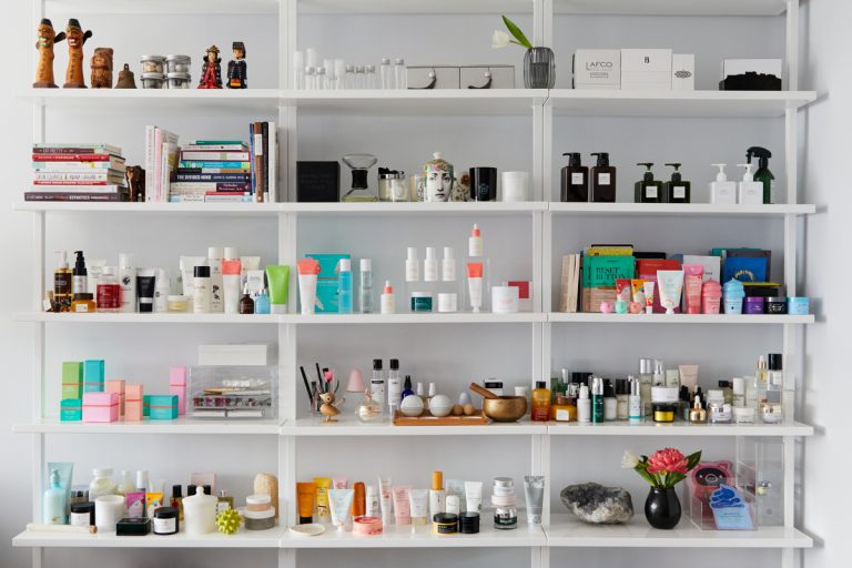 Shelves of skincare products, books, and candles.