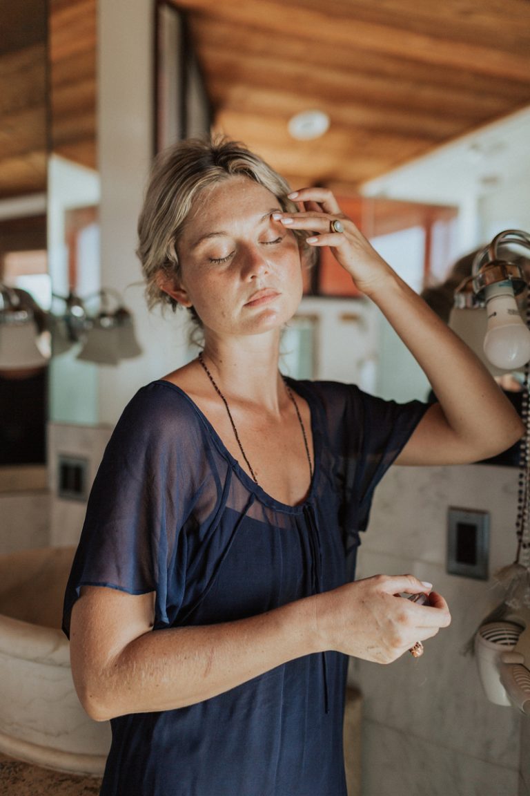 Woman massaging skincare around her eye and eyebrow