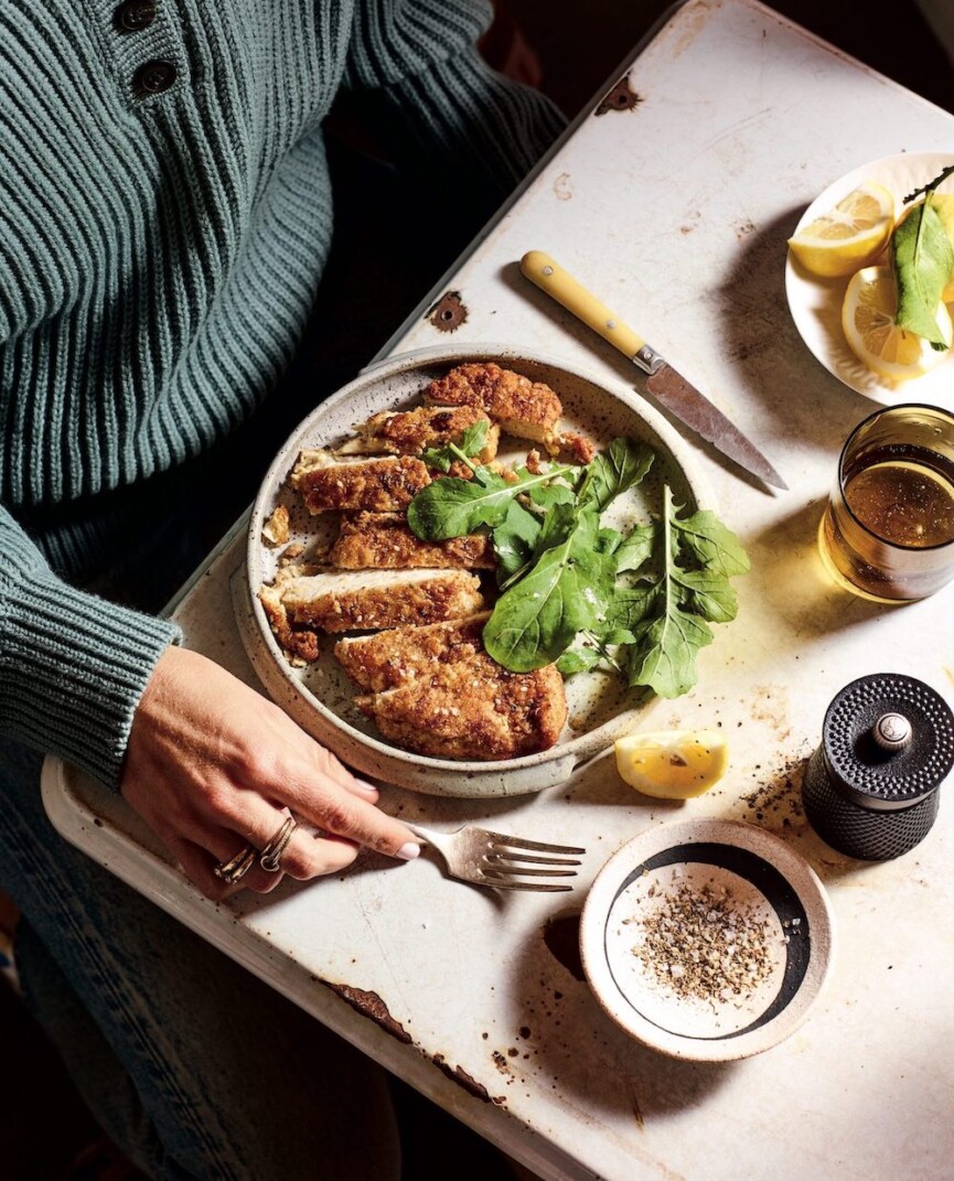 A table with a bowl of Zaatar crusted chicken