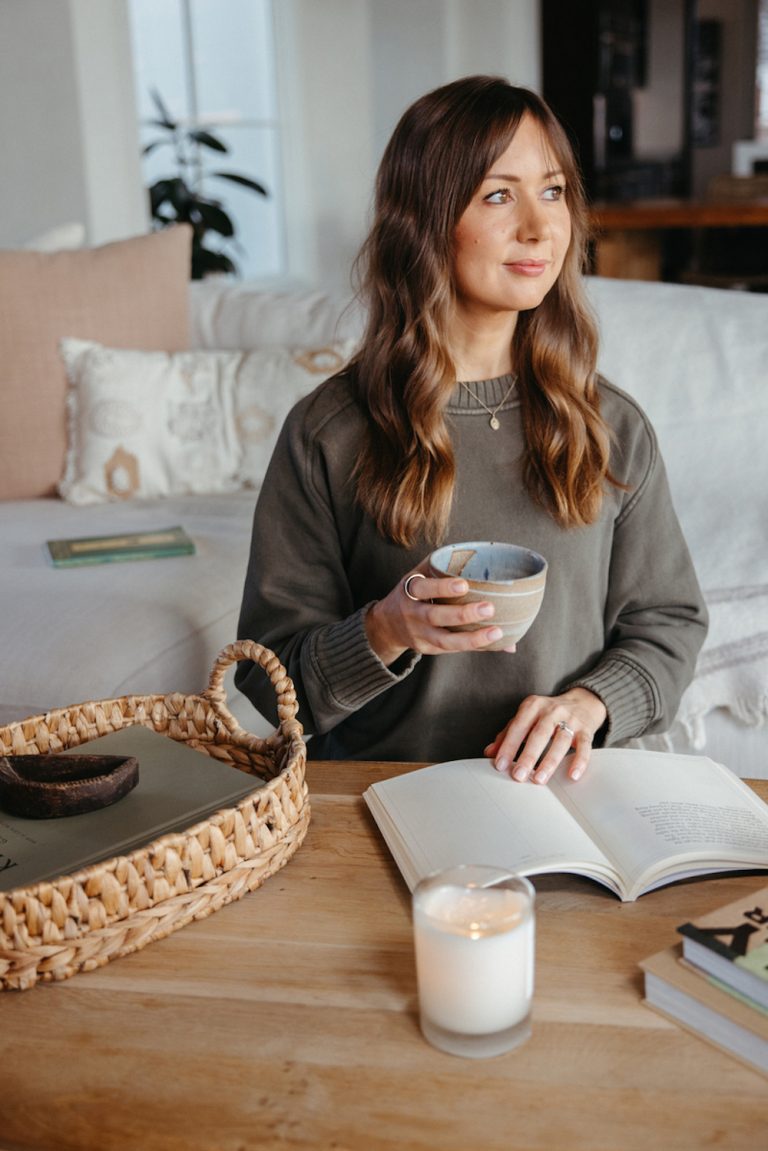 Camille Styles journaling drinking cup of tea.