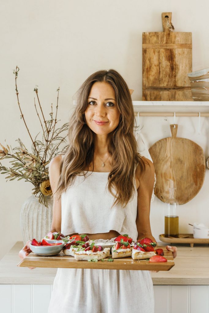 camille styles holding ricotta and plum bruschetta