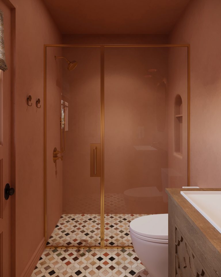 Pink, moody bathroom with gold accents.