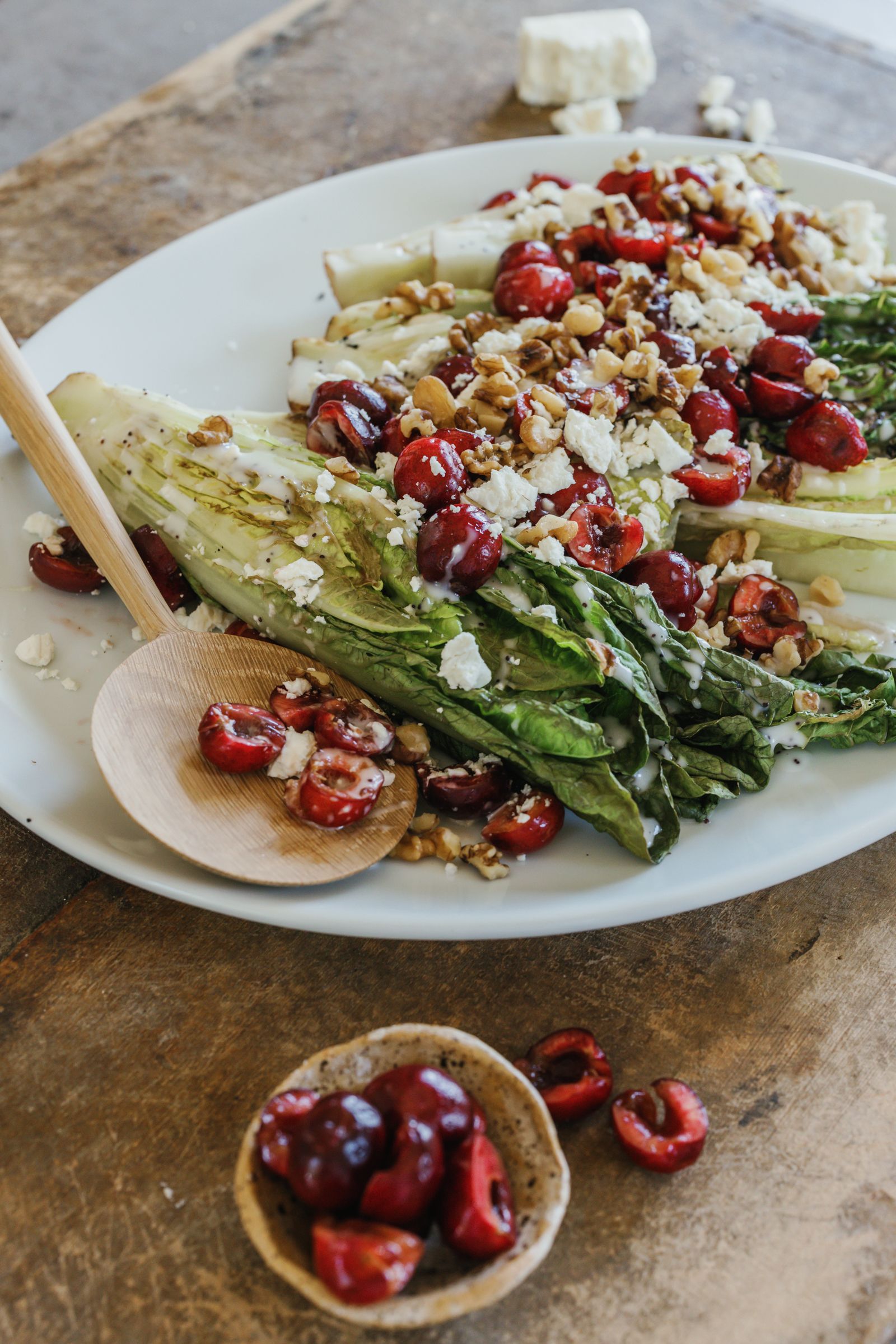 grilled romaine salad with a bowl of cherries