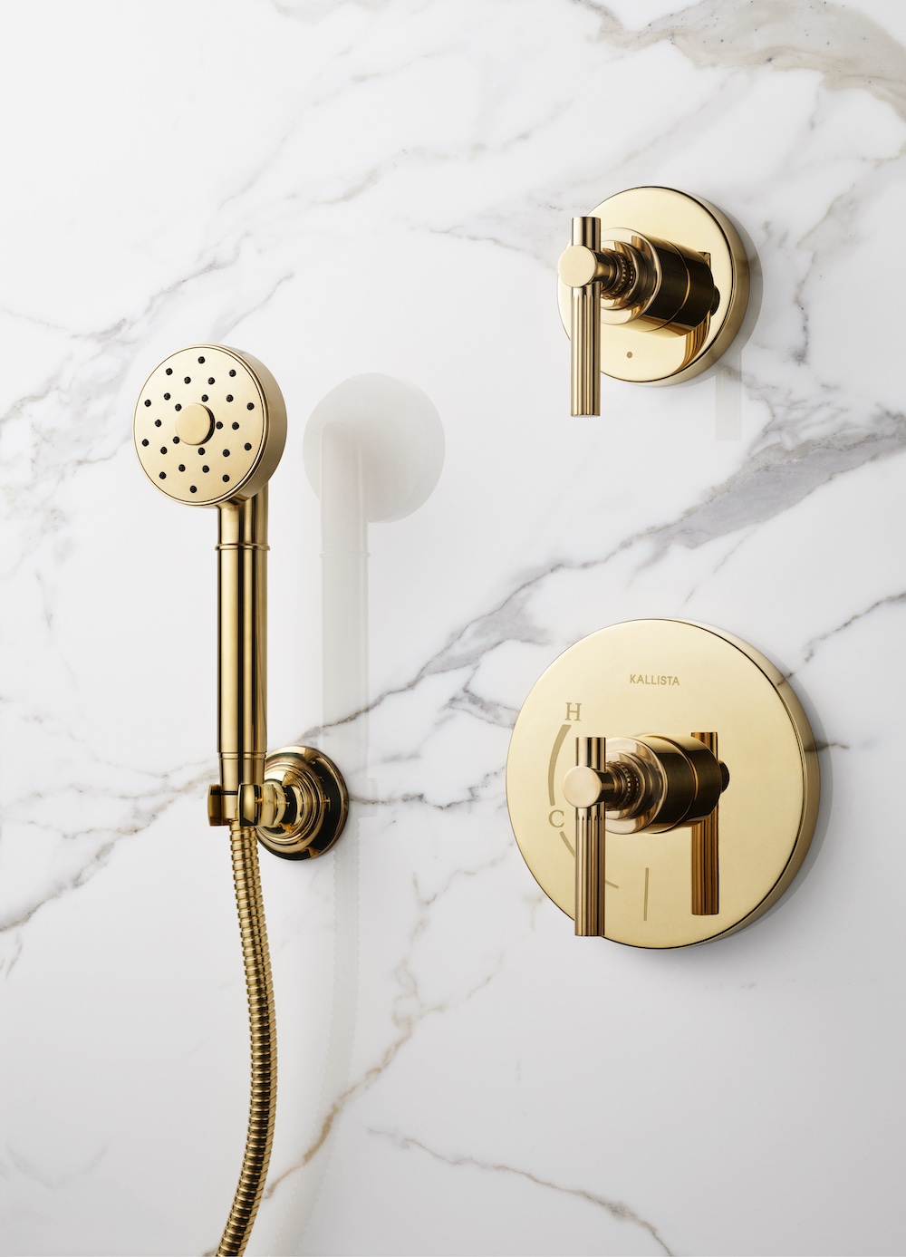 Kallista unlacquered brass shower with marble wall