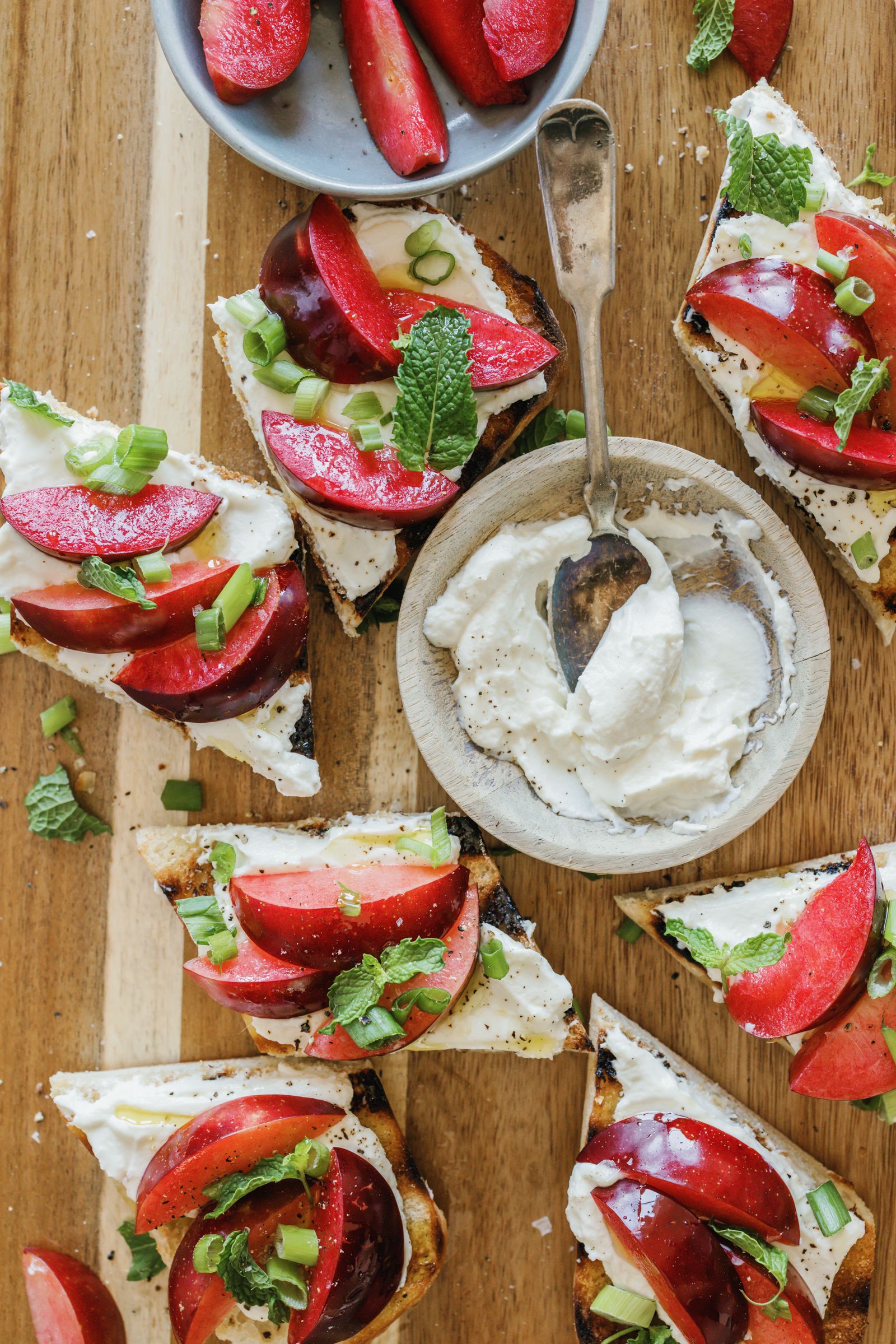 ricotta and plum bruschetta with cup of ricotta