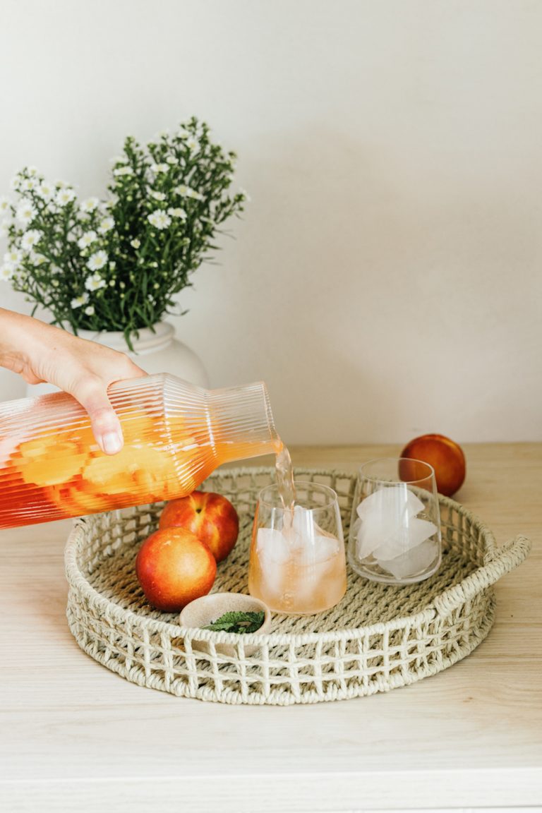 Pouring cocktail into stemless wine glasses.