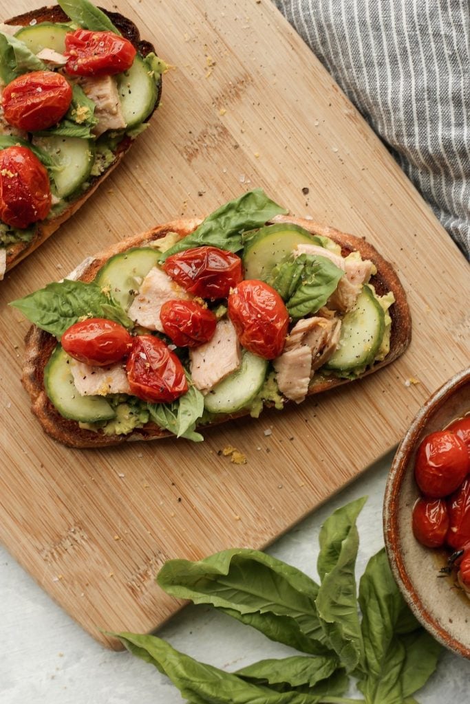 tuna and avocado toast with oven roasted tomatoes and pesto