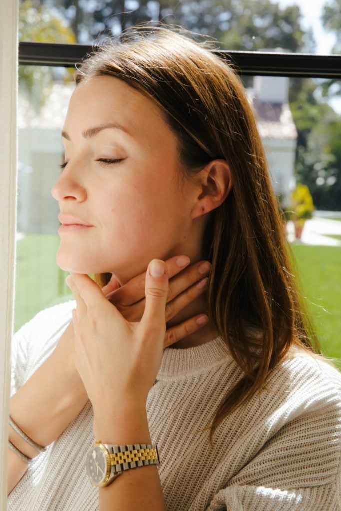 Woman doing facial massage.