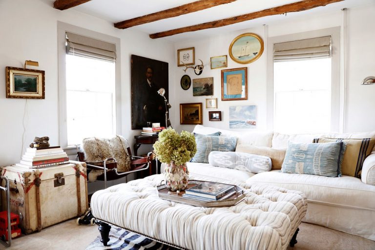 A cozy coastal grandmother aesthetic living room with a tufted coffee table