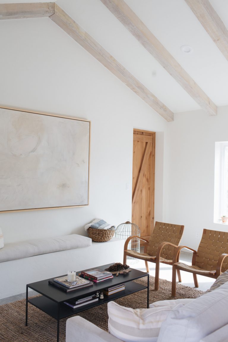 Minimalist, neutral living room with coffee table.