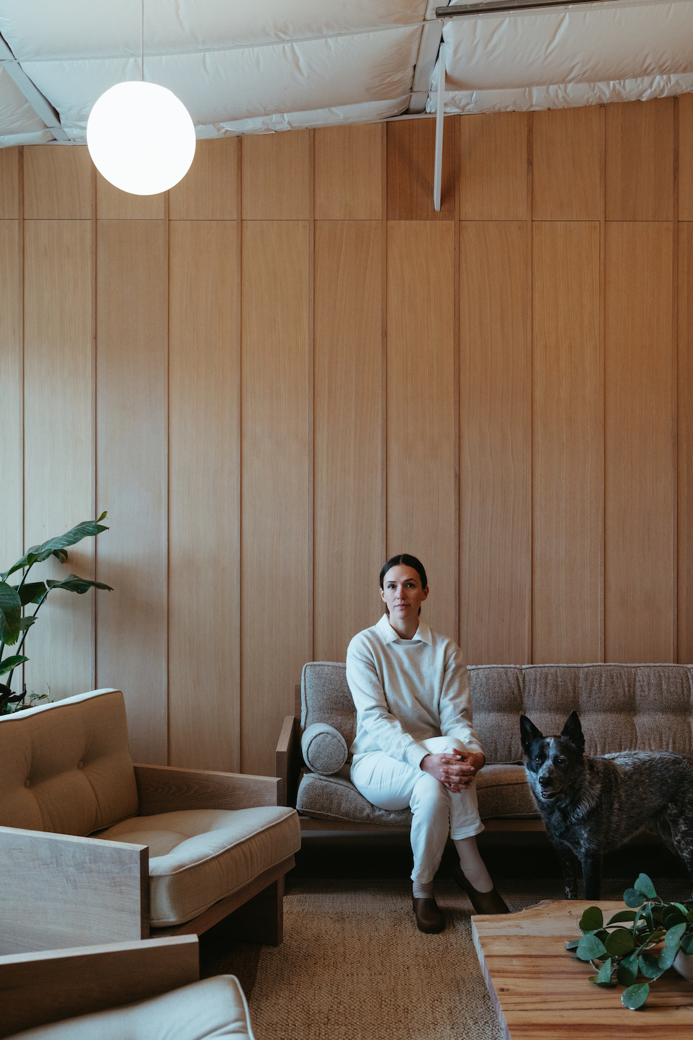 Adriene Mishler sitting in her Austin, Texas office with her dog.