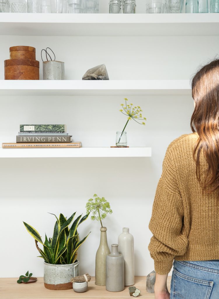 Woman standing in front of bookcase.