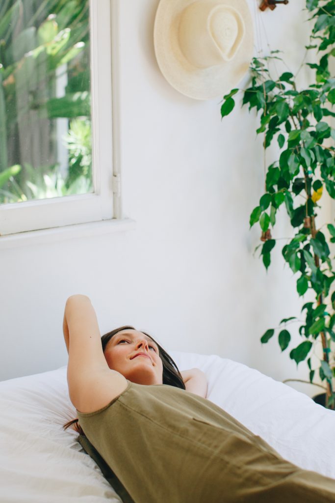 Woman lying on bed.