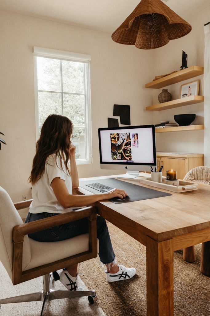 Woman working on computer at desk.