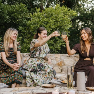 ladies doing cheers outside around fire pit