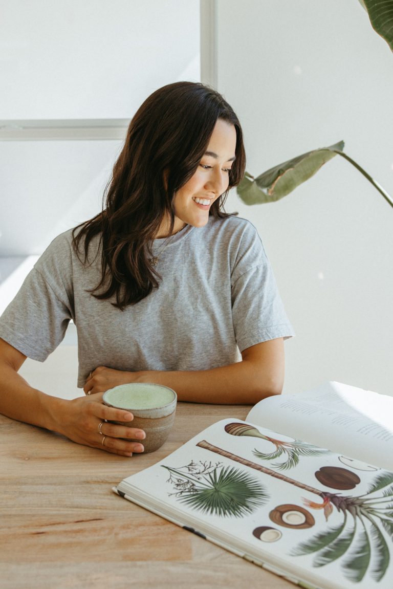 Woman reading drinking matcha.