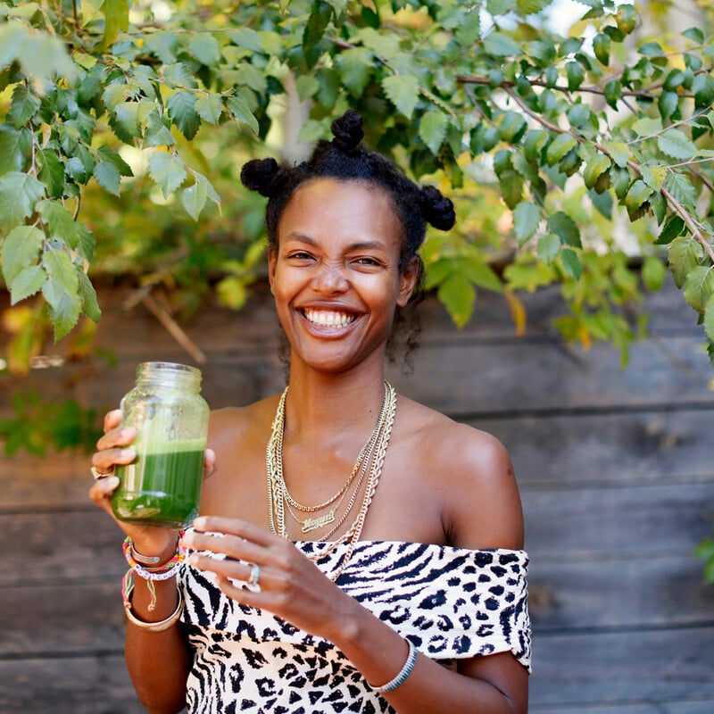 Woman drinking green juice.