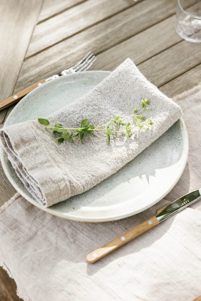 Neutral outdoor dining table setting.