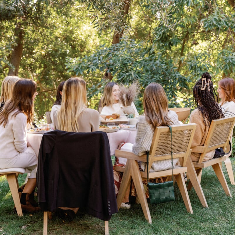 Women eating at outdoor dining table.