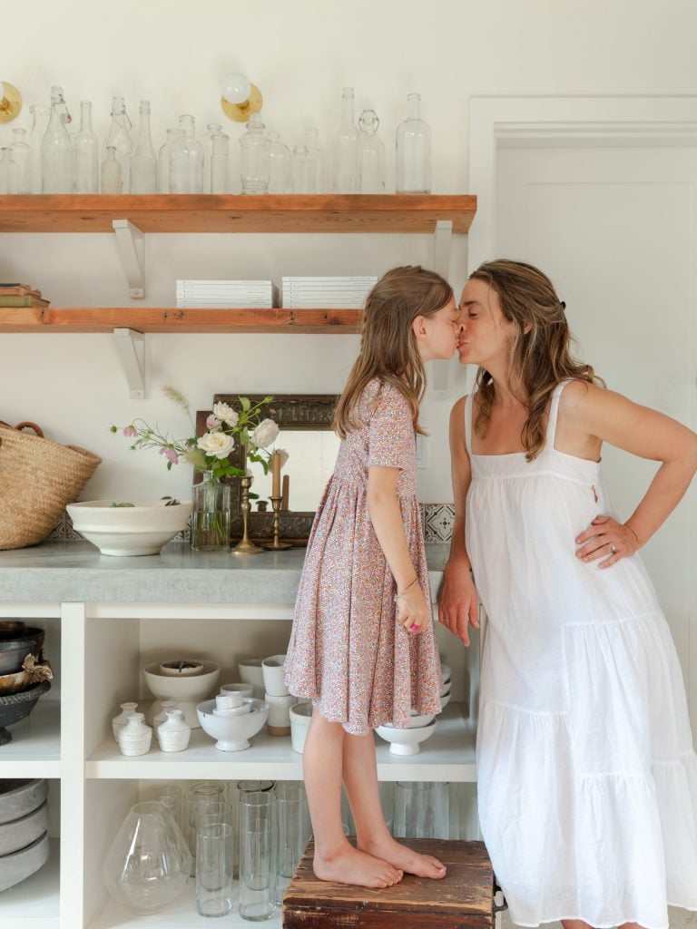 Woman embracing daughter.