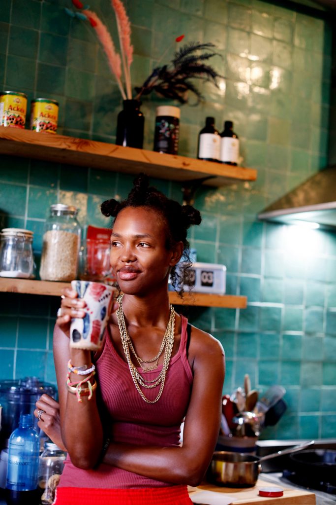 Woman drinking coffee in kitchen.