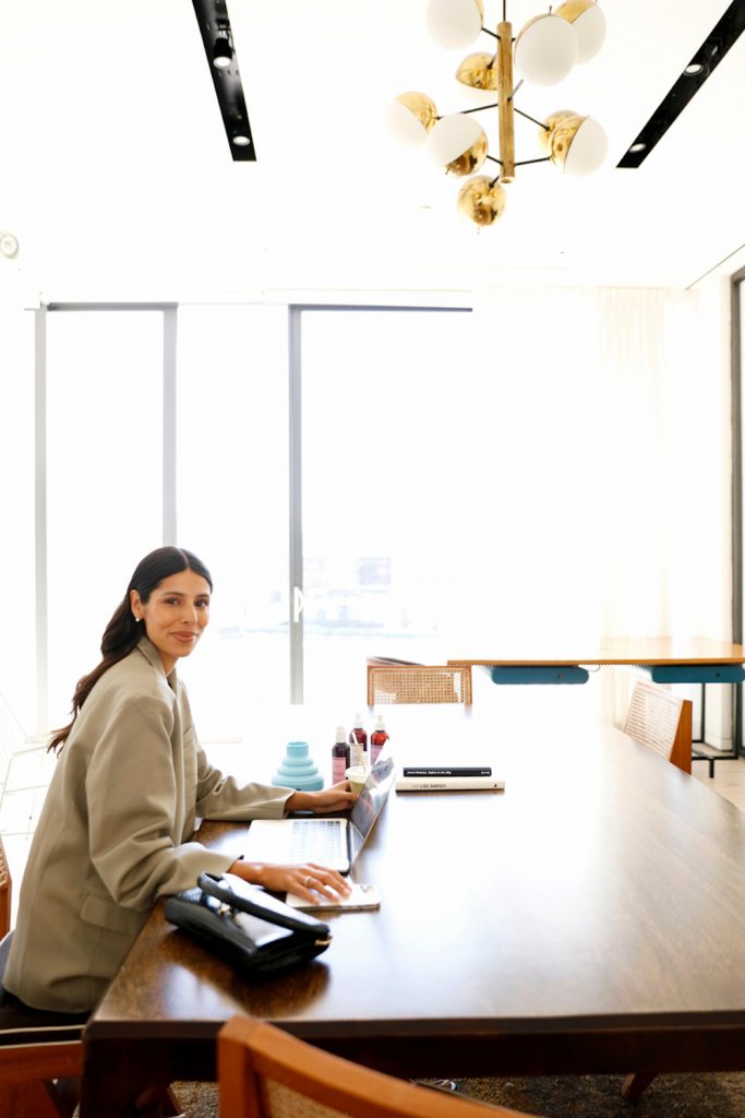 Woman working at large desk in office.