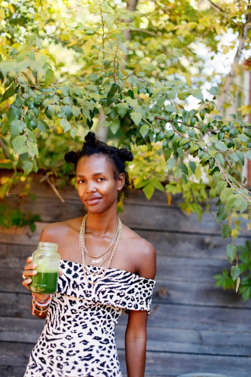 Woman holding green juice