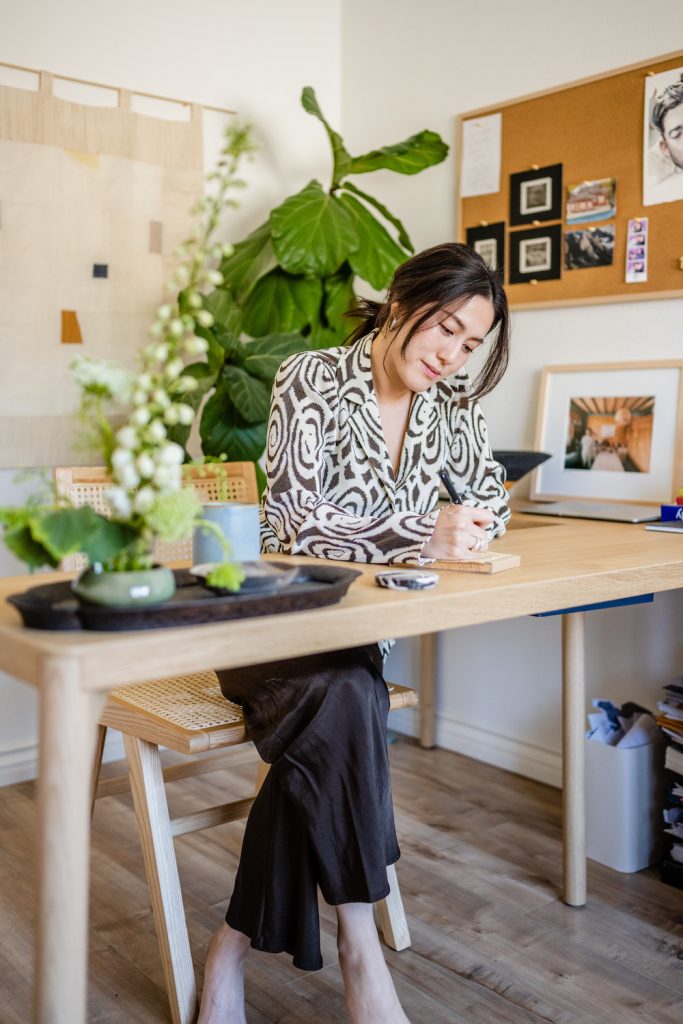 Woman writing at desk.