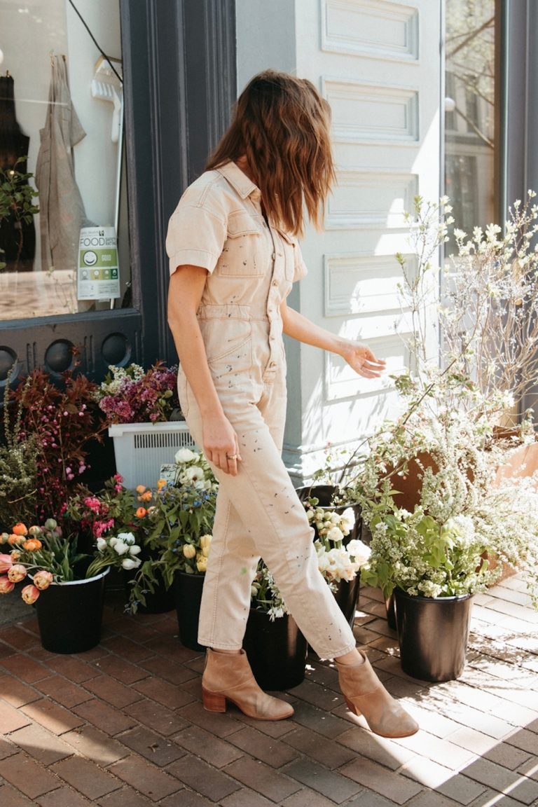 Woman wearing jumpsuit and boots.