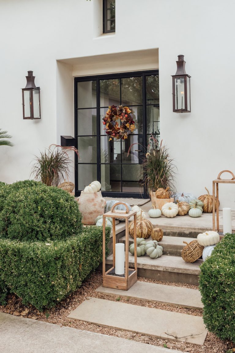 Fall-styled front door with pumpkins.