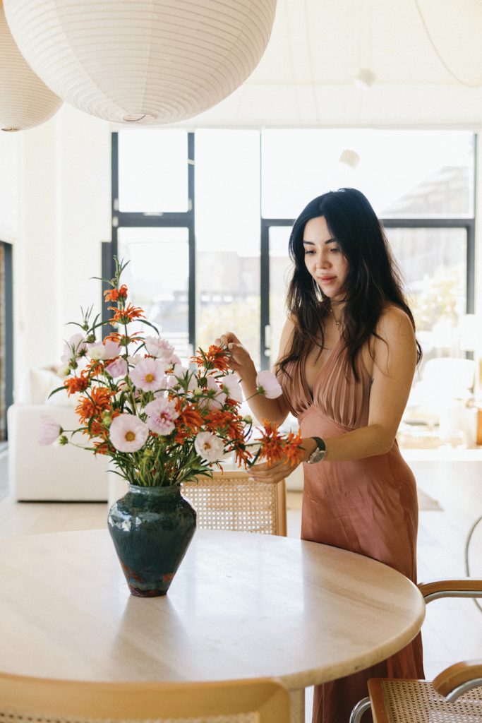 Woman arranging flowers.