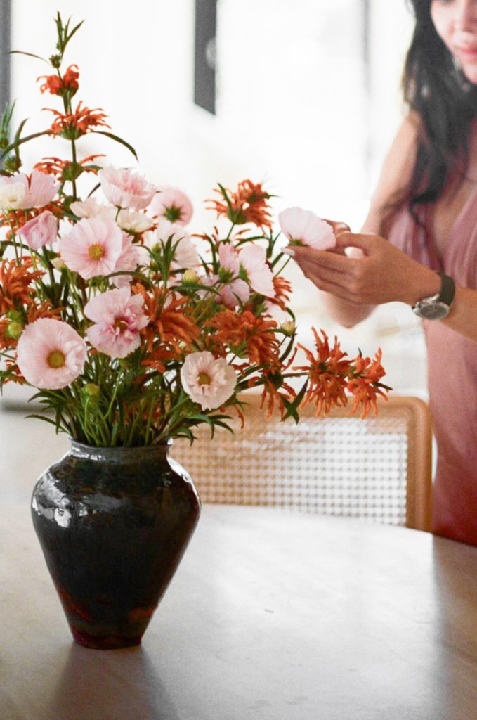 Woman arranging flowers.