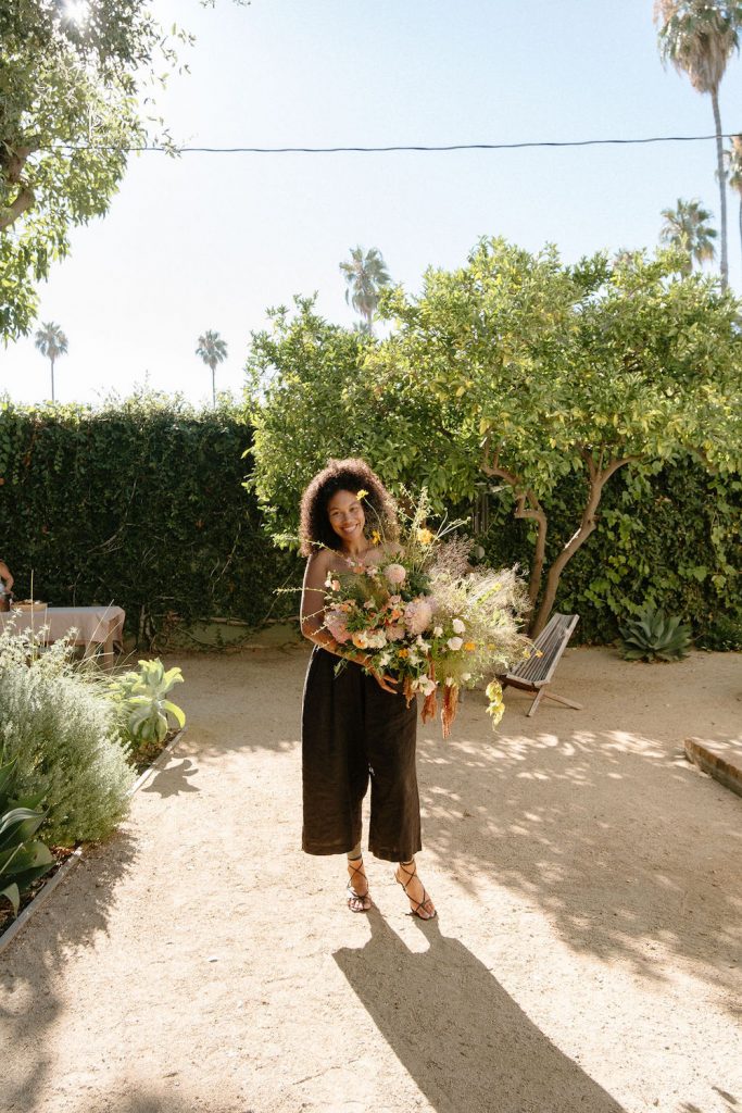 Woman carrying flowers.