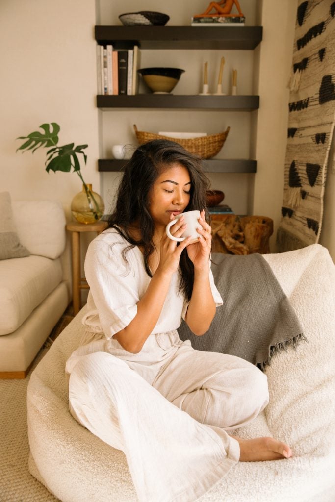 Woman drinking tea wearing loungewear.