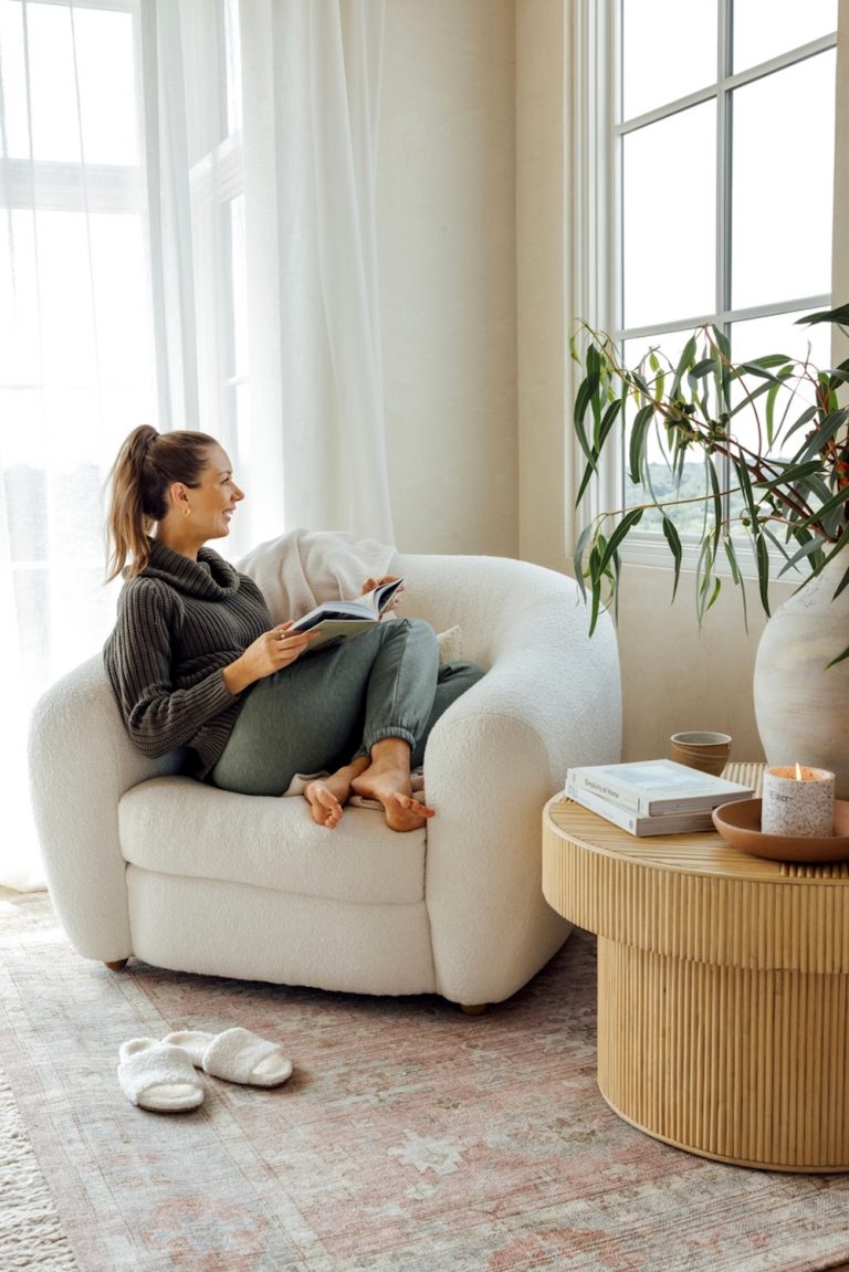 Woman reading in chair.