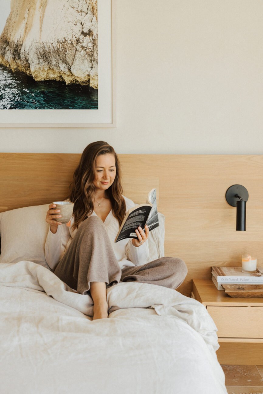 Camille Styles reading in bed.