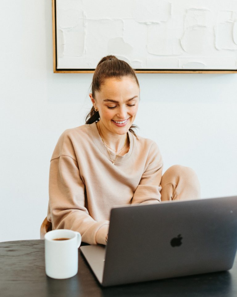 Woman working on laptop.