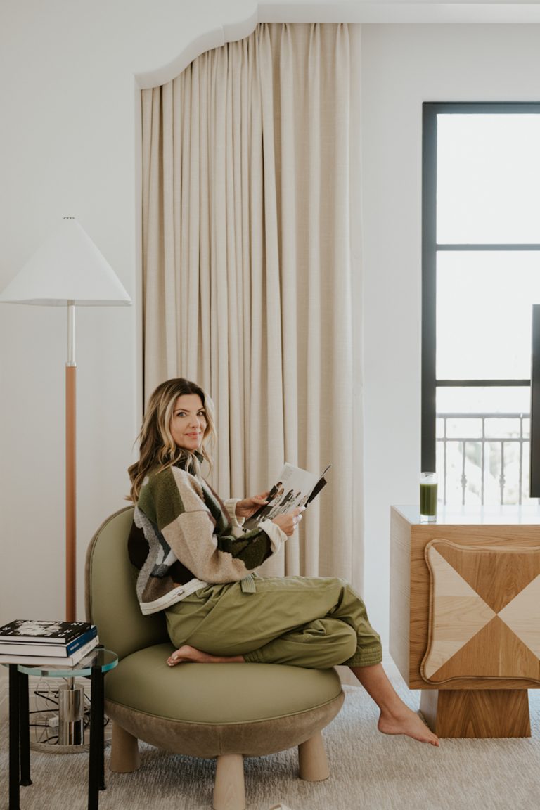 Woman reading in armchair.