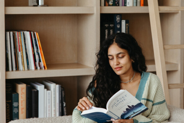 Woman reading on the couch.