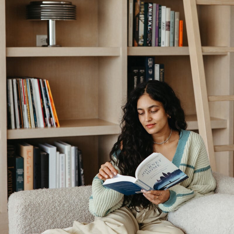 Woman reading on the couch.