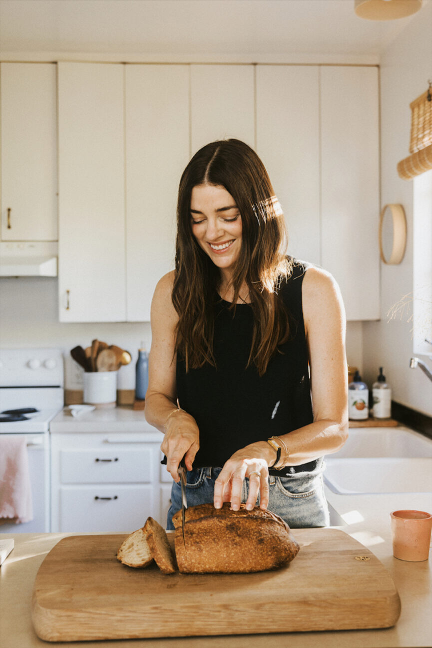 Woman slicing bread.