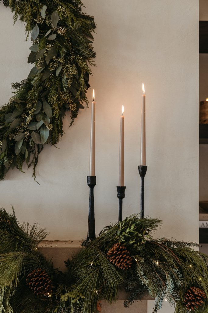 Camille Styles Holiday Decor 2023-Christmas Mantel with evergreen garland and casa zuma holiday wreath and candles