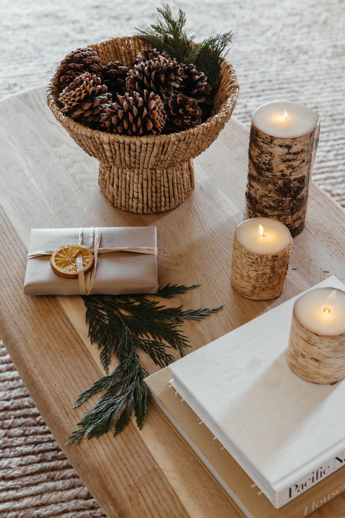 Camille Styles Holiday Decor 2023-pinecones on coffee table birch yelp candles
