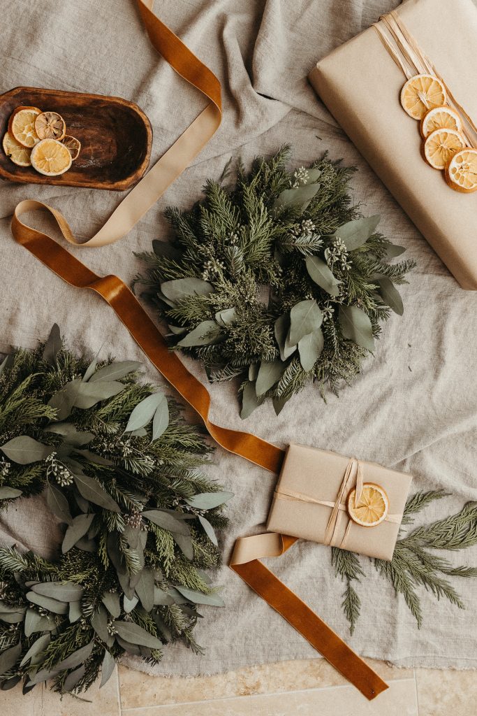 Camille Styles Holiday Decor 2023-Christmas tree with kraft paper presents and zestless citrus-rustic souvenir wrapping and evergreen casa zuma holiday wreath