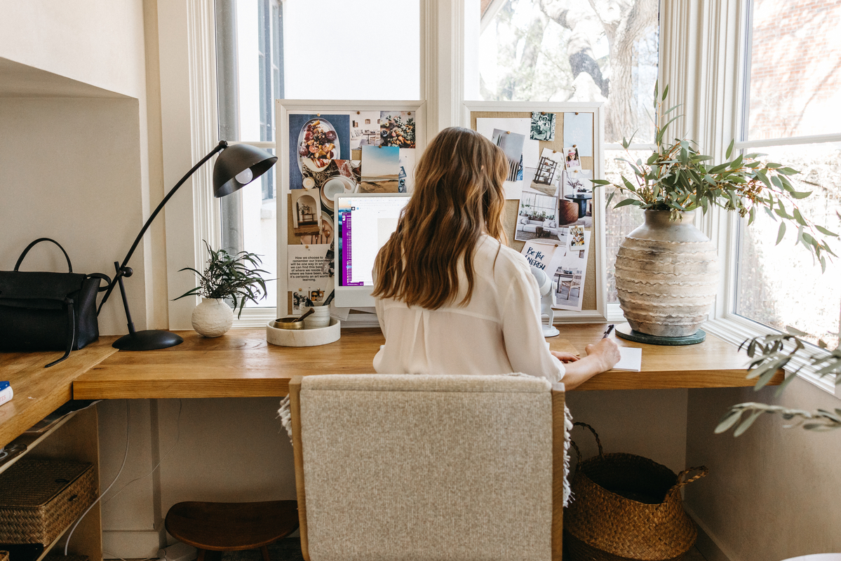 Camille Styles working at desk