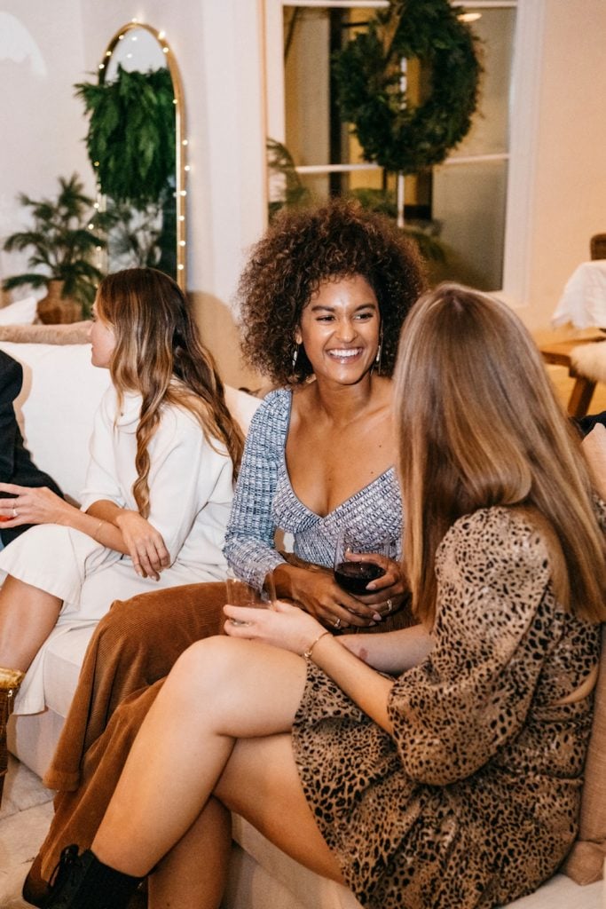 Women talking at party.